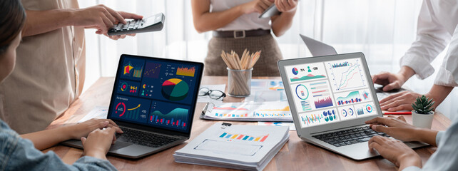Fototapete - Panorama shot analyst team utilizing BI Fintech to analyze financial report with laptop. Businesspeople analyzing BI power dashboard displayed on laptop screen for business insight. Scrutinize