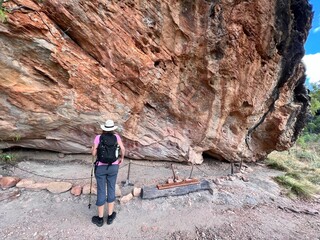 Australian woman look at Indigenous Australian rock art painting Cape York peninsula Queensland Australia