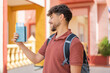 © luismolinero - Young Arabian handsome man holding a passport at outdoors with happy expression