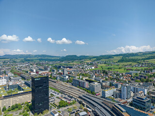 Wall Mural - Aerial view of Swiss City of Zug with railway station and black skyscraper on a sunny spring day. Photo taken May 22nd, 2023, Zug, Switzerland.