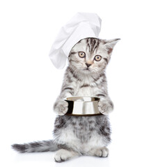 Poster - Funny tabby kitten wearing chef's hat holds empty bowl. isolated on white background