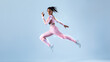 Futuristic training concept. Fit black woman in sportswear jumping, running