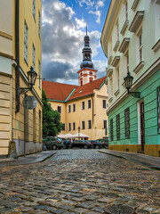 Wall Mural - Narrow cobblestone street among and colorful buildings in Old Town of Prague.