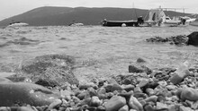 Herceg Novi Montenegro, August 8 2022 Sea Beach Vacation. Sea Trips And Fishing. Boats Float On The Sea Against The Backdrop Of Mountains. Black And White Monochrome Vintage Retro Video. Adriatic Sea.