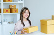 © mangpor2004 - Young asian small business owner holding prodect boxes while smiling and looking at camera, online shopping