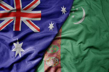 big waving realistic national colorful flag of australia and national flag of turkmenistan .