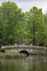 Wall Mural - A stone bridge over a lake in the UK countryside.