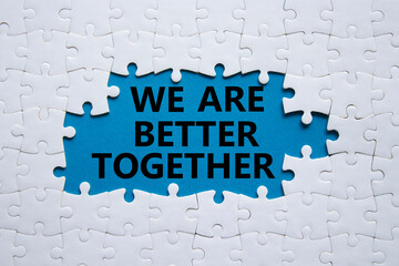 We are better together symbol. White puzzle with words We are better together. Beautiful blue background. We are better together concept. Copy space.