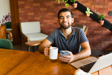 Wall Mural - Smiling attractive man happy about his remote freelance work