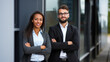 © JKLoma - Portrait of happy multi ethnic business couple posing with arms crossed