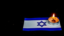 Israeli Flag And Candles Burning Above It, Holocaust Memory Day