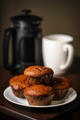 Sticker - a plate full of freshly baked muffins sitting on top of a wooden table