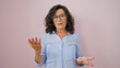 © Krakenimages.com - Middle age hispanic woman smiling confident speaking over isolated pink background