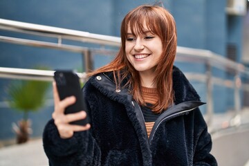 Poster - Young woman smiling confident using smartphone at street