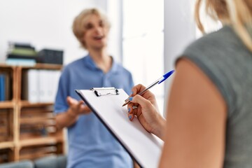 Poster - Young blond man patient having mental therapy standing at psychology clinic