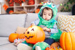 © Krakenimages.com - Adorable hispanic boy having halloween party holding pumpkin basket at home
