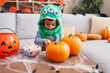 © Krakenimages.com - Adorable hispanic boy having halloween party holding sweets at home