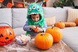 © Krakenimages.com - Adorable hispanic boy having halloween party holding sweets at home