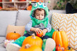© Krakenimages.com - Adorable hispanic boy having halloween party holding pumpkin basket at home