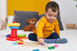 © Krakenimages.com - Adorable hispanic boy playing with maths puzzle game sitting on bed at bedroom