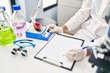 © Krakenimages.com - Young hispanic woman scientist weighing gemstone writing report at laboratory
