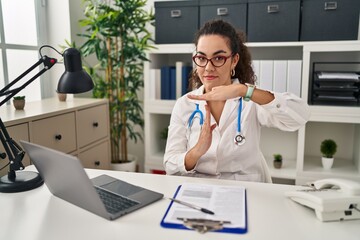 Canvas Print - Young hispanic woman wearing doctor uniform and stethoscope doing time out gesture with hands, frustrated and serious face