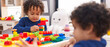 © Krakenimages.com - Adorable african american boys playing with construction blocks sitting on table at kindergarten