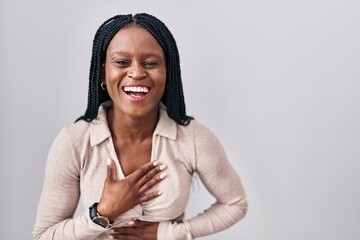 Sticker - African woman with braids standing over white background smiling and laughing hard out loud because funny crazy joke with hands on body.