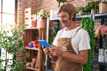 Sticker - Young blond man florist smiling confident using touchpad at flower shop