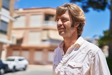 Poster - Young man with relaxed expression standing at street