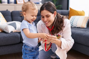 Mother and son doctor examining child at home