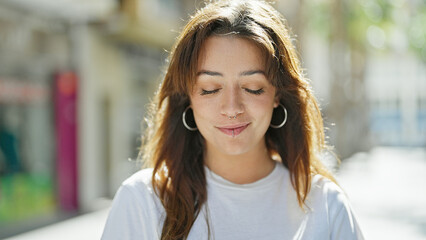 Sticker - Young beautiful hispanic woman standing with serious expression looking down at street