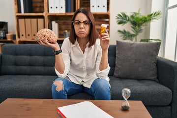 Sticker - Young hispanic woman working on depression holding pills depressed and worry for distress, crying angry and afraid. sad expression.