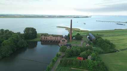 Poster - Aerial of the Wouda pumping station in Lemmer, Netherlands alongside the sea and the green field