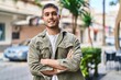 © Krakenimages.com - Young hispanic man smiling confident standing with arms crossed gesture at street