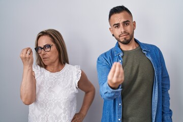 Sticker - Hispanic mother and son standing together doing italian gesture with hand and fingers confident expression