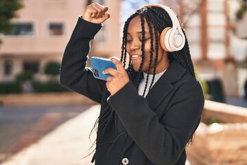 Poster - African american woman smiling confident playing video game at street