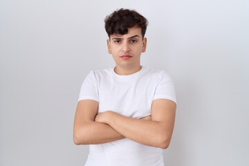 Sticker - Young non binary man wearing casual white t shirt skeptic and nervous, disapproving expression on face with crossed arms. negative person.