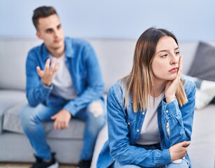 Sticker - Man and woman couple arguing sitting on sofa at home