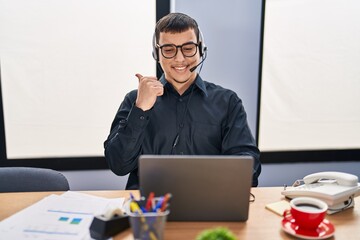 Poster - Young arab man wearing call center agent headset pointing thumb up to the side smiling happy with open mouth