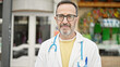 © Krakenimages.com - Middle age man doctor standing with serious expression at street