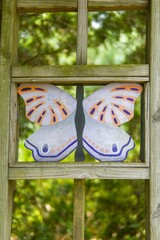 Poster - Close-up of a colorful butterfly painted on a glass window