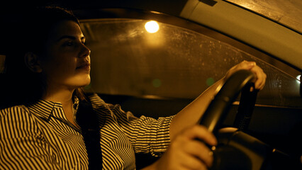 Young beautiful hispanic woman driving a car on the road