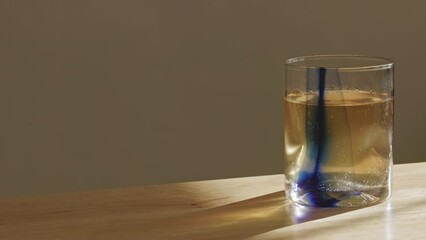 Canvas Print - Glass full of sparkling juice put on the wooden table against the wall