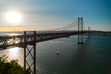 Sticker - Aerial shot of The 25 de Abril Bridge  crossing Tagus River is a suspension bridge connecting the city of Lisbon and Almada. Sunny summer day. Portugal