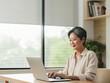© Natalya - A Mature Asian Woman Embracing Remote Work