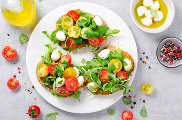 Wall Mural - Bruschetta with Cherry Tomatoes, Mini Mozzarella Cheese and Pesto Sauce, Caprese Toasts