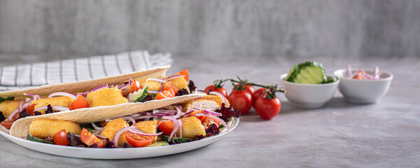 Poster - Delicious tortilla with chicken nuggets, vegetables, onions and lettuce on a plate web banner