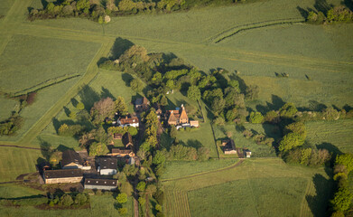 Wall Mural - Aerial view of a farm with oast houses in the countryside in Kent, UK