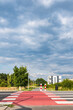 Droga rowerowa o letniej porze w obszarach podmiejskich zachodniej Polski w tle błękitne pochmurne niebo